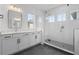 Elegant bathroom featuring a glass-enclosed shower, dual vanities, and modern fixtures at 908 Tilden Oaks Trl, Winter Garden, FL 34787