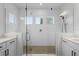 Contemporary bathroom with a large glass shower enclosure and dual sink vanities at 908 Tilden Oaks Trl, Winter Garden, FL 34787