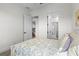 Bright bedroom featuring neutral tones, open doorways, and plush carpeting at 908 Tilden Oaks Trl, Winter Garden, FL 34787