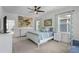 Inviting bedroom featuring a decorative accent wall, king bed, and ample natural light at 908 Tilden Oaks Trl, Winter Garden, FL 34787