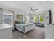 Bright bedroom featuring a king bed, stylish furnishings, and abundant natural light from multiple windows at 908 Tilden Oaks Trl, Winter Garden, FL 34787