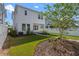 A two-story white home featuring a manicured lawn and sidewalk at 908 Tilden Oaks Trl, Winter Garden, FL 34787