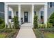 Inviting front porch with rocking chairs, a swing, and manicured landscaping creating a welcoming entrance at 908 Tilden Oaks Trl, Winter Garden, FL 34787