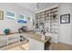 Bright office featuring built-in bookcases, storage, and large windows, creating a functional workspace at 908 Tilden Oaks Trl, Winter Garden, FL 34787