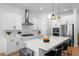 Modern kitchen with white cabinets, stainless steel appliances, and a view of the dining area at 908 Tilden Oaks Trl, Winter Garden, FL 34787