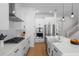 Bright kitchen featuring white cabinets, stainless steel appliances, and an island with a sink at 908 Tilden Oaks Trl, Winter Garden, FL 34787