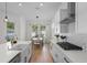 Kitchen with stainless steel appliances, white cabinets and counters, and wood flooring at 908 Tilden Oaks Trl, Winter Garden, FL 34787