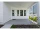 Covered patio with direct backyard access, featuring white trim and serene outdoor views at 908 Tilden Oaks Trl, Winter Garden, FL 34787