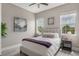 This cozy bedroom has wood flooring and plenty of natural light from the windows at 9255 Doherty Pl, Orlando, FL 32827