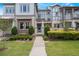 Charming townhome with lush landscaping, and a welcoming walkway leading to the front door at 9255 Doherty Pl, Orlando, FL 32827