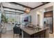 Open kitchen and living area with granite counters, stainless steel appliances, and modern lighting at 9255 Doherty Pl, Orlando, FL 32827