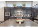 Well-appointed kitchen with stainless steel appliances, sleek dark cabinets and granite countertops at 9255 Doherty Pl, Orlando, FL 32827
