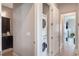 Convenient laundry room with stacked washer and dryer near the bathroom at 9255 Doherty Pl, Orlando, FL 32827