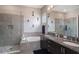 Bright main bathroom with a double sink vanity, soaking tub, and glass enclosed shower at 9255 Doherty Pl, Orlando, FL 32827