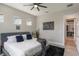 Comfortable main bedroom with grey headboard, modern decor, and wood-look flooring at 9255 Doherty Pl, Orlando, FL 32827
