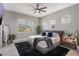 Light filled main bedroom with a large window, plush rug, and modern decor at 9255 Doherty Pl, Orlando, FL 32827