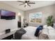 This contemporary main bedroom features a ceiling fan, television, and an ensuite bathroom with double sinks at 9255 Doherty Pl, Orlando, FL 32827