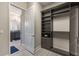Spacious walk-in closet with custom shelving, drawers, and a secure safe at 9255 Doherty Pl, Orlando, FL 32827