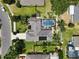 Aerial view of home showcasing a large screened pool and manicured lawn at 97 Desiree Aurora St, Winter Garden, FL 34787