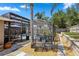 Secluded backyard seating area with lush landscaping near a screened pool enclosure at 97 Desiree Aurora St, Winter Garden, FL 34787