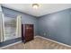 Serene bedroom with a vintage dresser, soft carpet, and ample natural light at 97 Desiree Aurora St, Winter Garden, FL 34787