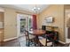 Cozy dining area with backyard pool view, complemented by a modern entertainment setup at 97 Desiree Aurora St, Winter Garden, FL 34787