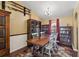 Charming dining room featuring built-in bookcases, wooden table, and warm lighting at 97 Desiree Aurora St, Winter Garden, FL 34787