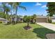 Charming single-story home with a lush green lawn, mature trees, and well-maintained landscaping at 97 Desiree Aurora St, Winter Garden, FL 34787