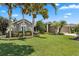 Charming single-story home with a lush green lawn, mature trees, and well-maintained landscaping at 97 Desiree Aurora St, Winter Garden, FL 34787