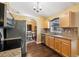 Well-lit kitchen with granite countertops, stainless steel appliances, and wood cabinetry at 97 Desiree Aurora St, Winter Garden, FL 34787