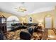 Comfortable living room featuring hardwood flooring, dark leather seating, and vaulted ceilings at 97 Desiree Aurora St, Winter Garden, FL 34787