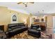 Cozy living room featuring hardwood flooring, comfortable leather seating, and open access to the kitchen at 97 Desiree Aurora St, Winter Garden, FL 34787