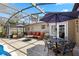 Screened patio featuring outdoor dining area, seating, and access to the pool at 97 Desiree Aurora St, Winter Garden, FL 34787