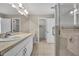 Bright bathroom featuring a glass-enclosed shower, modern fixtures, and an elegant vanity area at 1005 Turkey Hollow Cir, Winter Springs, FL 32708