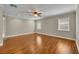 Spacious bedroom featuring hardwood floors, a ceiling fan, two windows, and neutral paint at 1005 Turkey Hollow Cir, Winter Springs, FL 32708