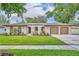Charming home featuring a well-maintained lawn, a two car garage, and enhanced curb appeal at 1005 Turkey Hollow Cir, Winter Springs, FL 32708