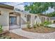Inviting front entrance with a paved brick path leading to a stylish, paneled front door at 1005 Turkey Hollow Cir, Winter Springs, FL 32708