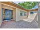Stylish, paneled front door of this home with a brick-paved patio at 1005 Turkey Hollow Cir, Winter Springs, FL 32708