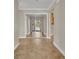 Bright hallway featuring tile flooring and a mirrored closet door, enhancing the sense of space at 1005 Turkey Hollow Cir, Winter Springs, FL 32708