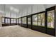 Relaxing enclosed patio with neutral tile, large sliding windows with backyard views, and plenty of natural light at 1005 Turkey Hollow Cir, Winter Springs, FL 32708