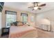 Cozy bedroom with a ceiling fan, two windows, and neutral paint colors at 1065 Clifton Springs Ln, Winter Springs, FL 32708