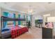 A bedroom featuring a bunk bed, ceiling fan, and large windows overlooking the front yard at 1065 Clifton Springs Ln, Winter Springs, FL 32708