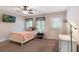 Cozy bedroom featuring neutral tones, a ceiling fan, and natural light from two windows at 1065 Clifton Springs Ln, Winter Springs, FL 32708
