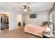 Neutral bedroom with ceiling fan, tv, walk-in closet, and ensuite bathroom at 1065 Clifton Springs Ln, Winter Springs, FL 32708