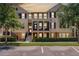 Attractive two-story townhome with a charming front porch and well-maintained landscaping at 1065 Clifton Springs Ln, Winter Springs, FL 32708