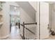 Hallway view leading to the kitchen and featuring a staircase and tile floors at 1065 Clifton Springs Ln, Winter Springs, FL 32708