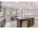 Well-lit kitchen featuring an island, stainless steel appliances, and an adjacent dining area at 1065 Clifton Springs Ln, Winter Springs, FL 32708
