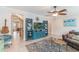 Bright living room with a blue entertainment center, ceiling fan, and comfortable seating area at 1065 Clifton Springs Ln, Winter Springs, FL 32708