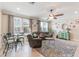 Inviting living room featuring a large sectional, dining area, and bright natural light at 1065 Clifton Springs Ln, Winter Springs, FL 32708