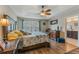 This spacious bedroom features a tray ceiling, ceiling fan, wood floors, and ensuite bathroom access at 1065 Clifton Springs Ln, Winter Springs, FL 32708
